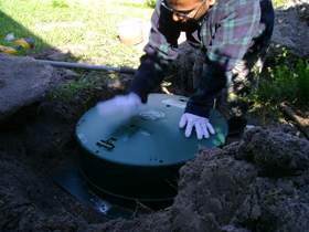 Installing a riser on the septic tank for easy access to clean filter and for pumping